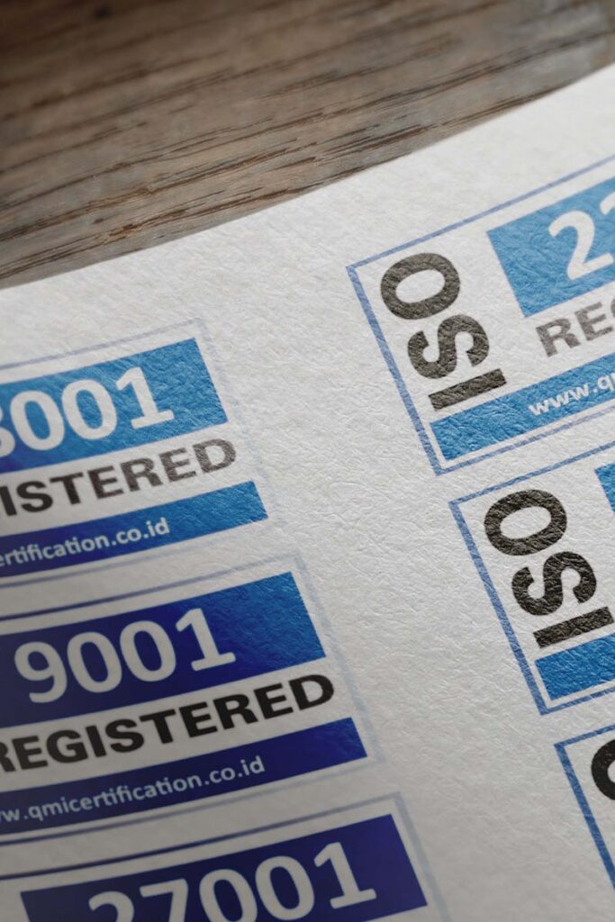 ISO certification stickers with registration numbers on paper.